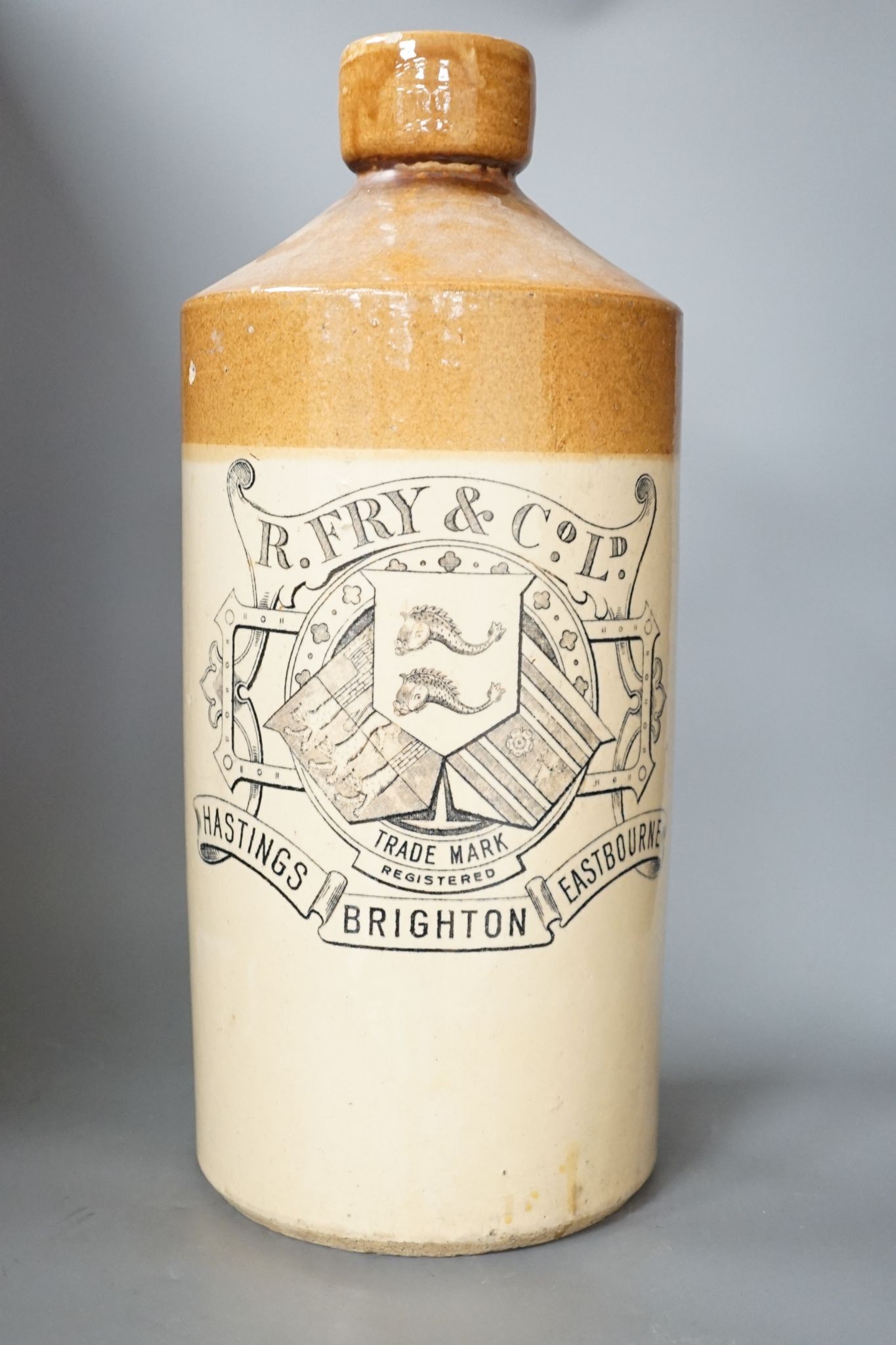 A stoneware bottle, R Fry & Co Ltd, Hastings, Brighton and Eastbourne, stamped Doulton Lambeth, 47 cms high.